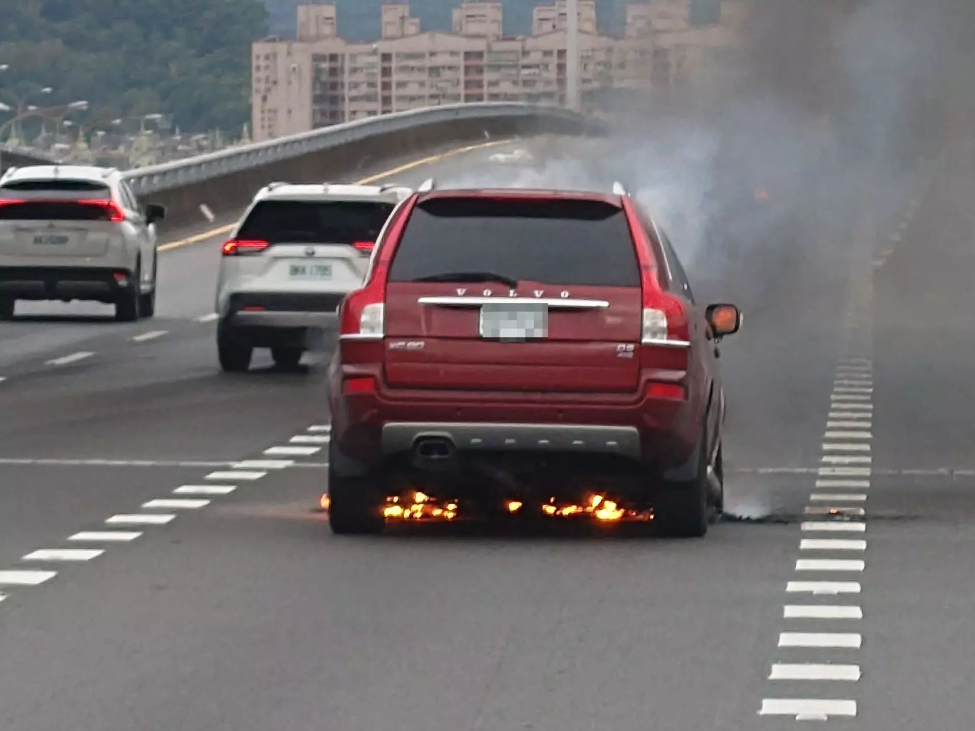 ▲車輛在行進間突然冒煙失火。（翻攝畫面）