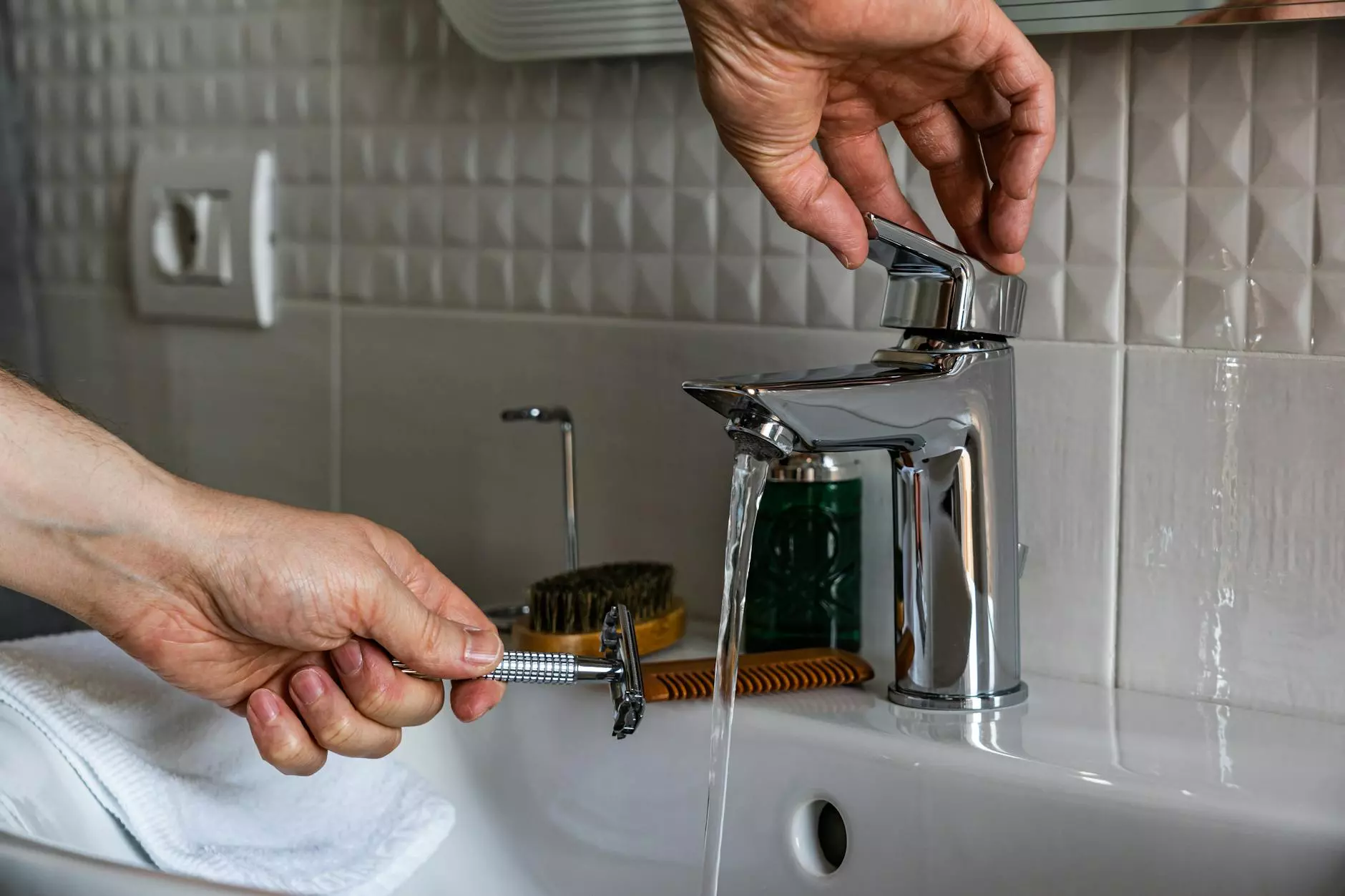 person holding stainless steel faucet