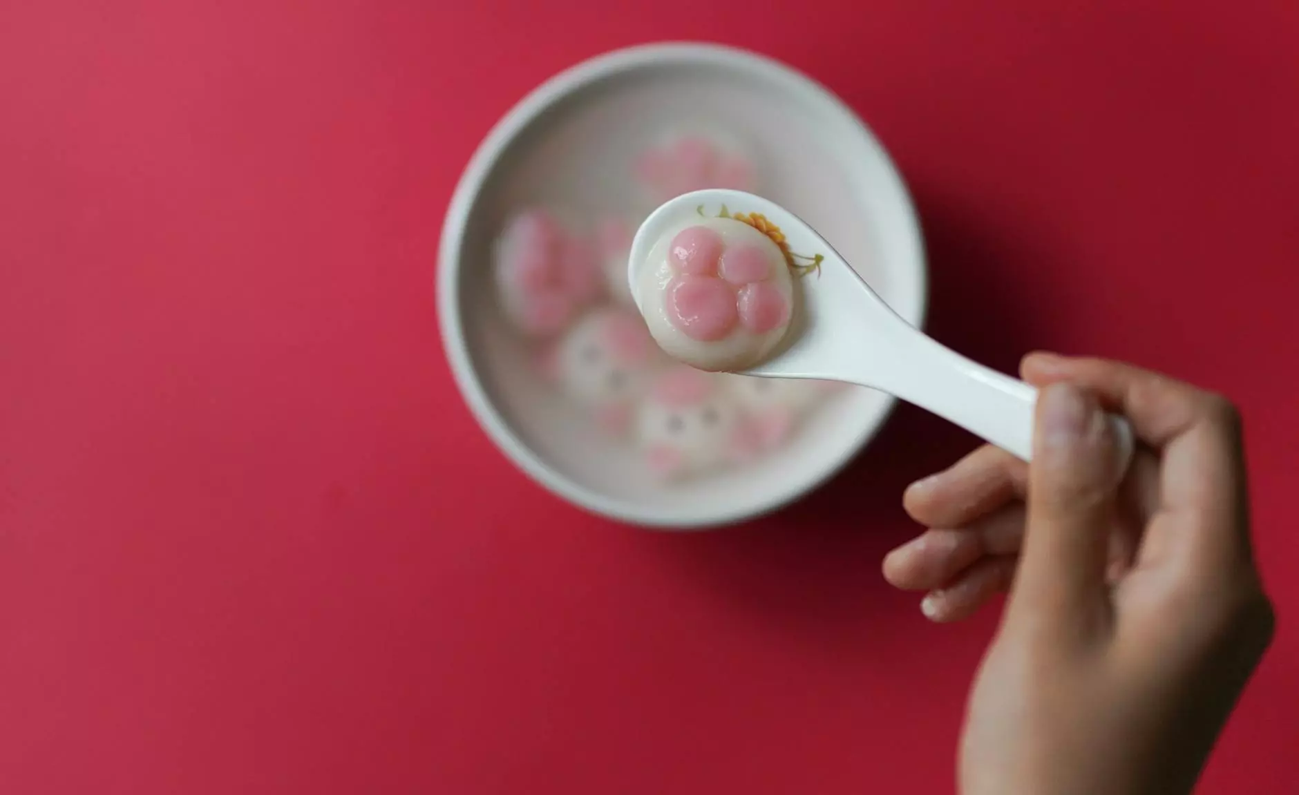 person holding spoon with food