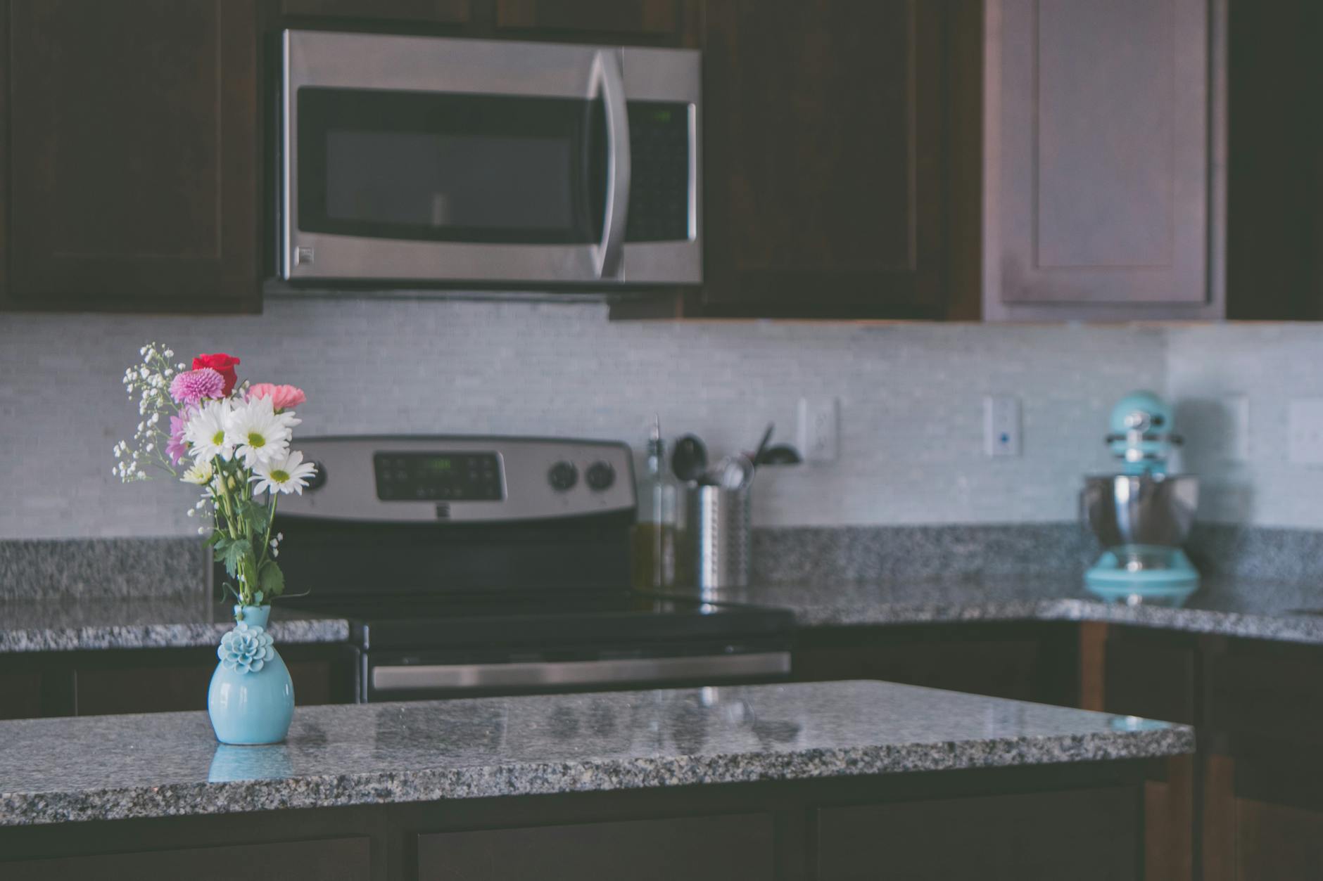 flowers on vase on a kitchen counter